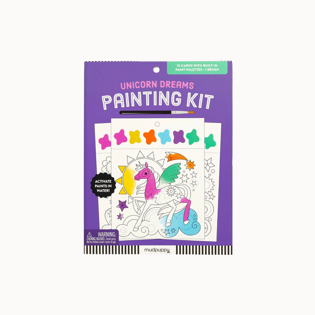 A packaged children's activity product titled 'Unicorn Dreams Painting Kit' on a plain light background. The package is predominantly purple with a unicorn painting illustration and several small rainbow-colored star shapes shown on the front.