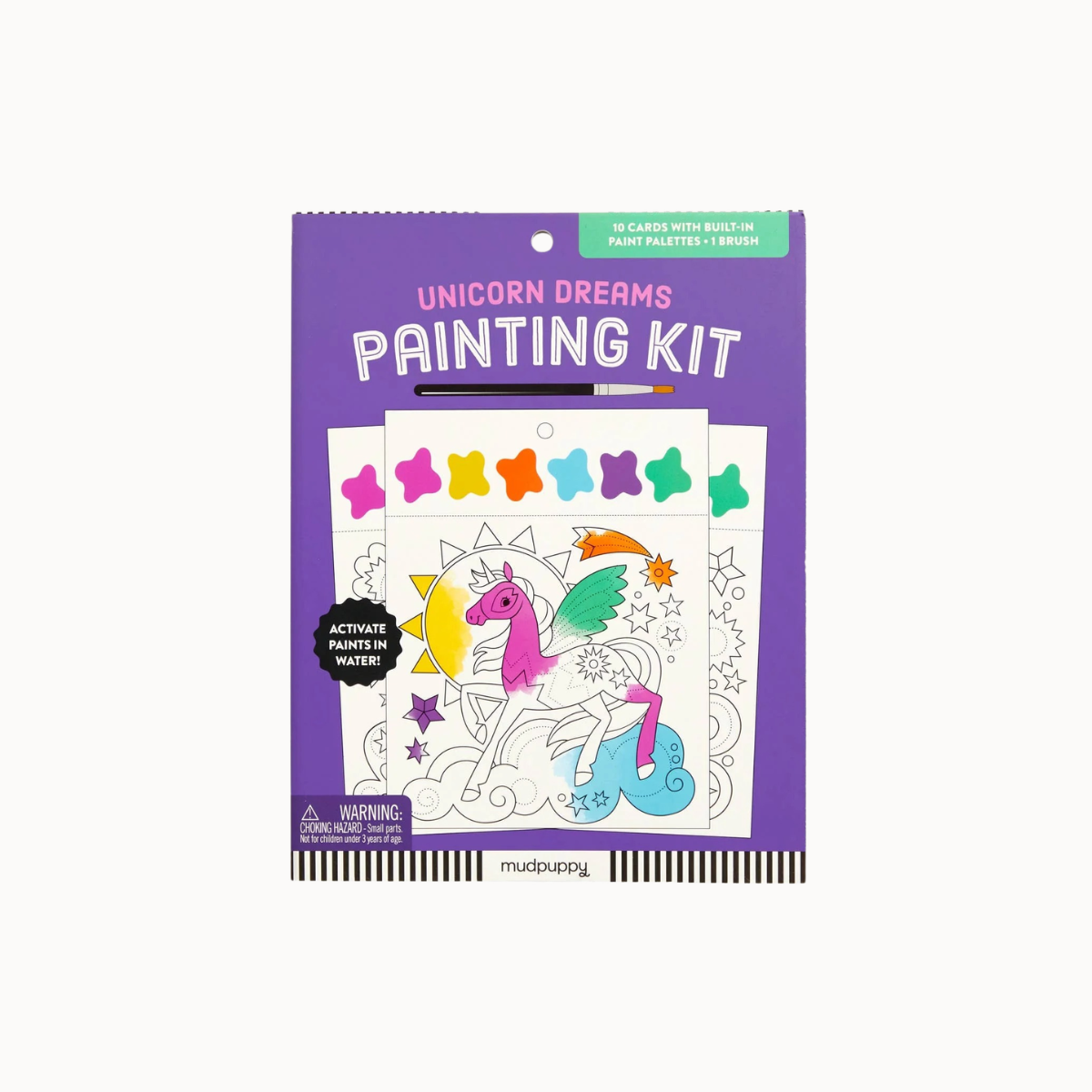 A packaged children's activity product titled 'Unicorn Dreams Painting Kit' on a plain light background. The package is predominantly purple with a unicorn painting illustration and several small rainbow-colored star shapes shown on the front.