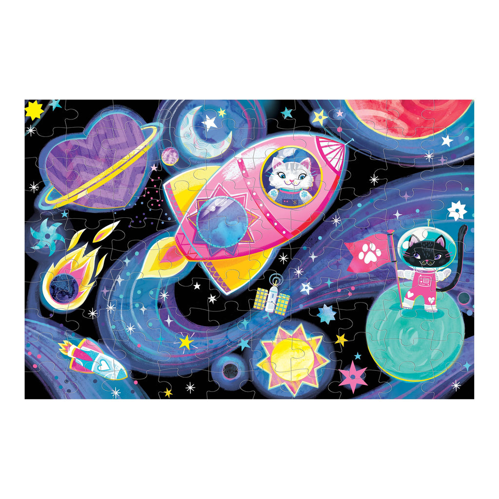 A colorful children's jigsaw puzzle featuring cartoon cats in space, with a pink rocket, planets, stars, and a black cat astronaut on a blue swirling cosmic background.
