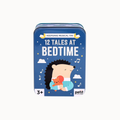 A blue metal tin for keepsake musical toys with the title '12 TALES AT BEDTIME' and a cartoon hedgehog holding a red teddy bear on the front. The brand 'petit english' is visible in the bottom right corner.
