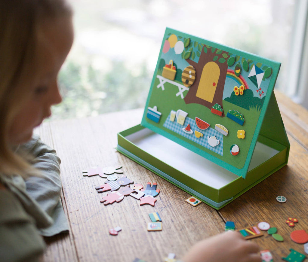 Child playing with a colorful children's puzzle on a wooden table.