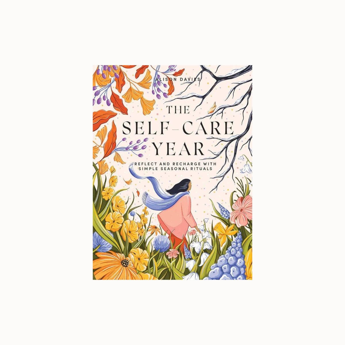 The Self Care Year book cover by Ann Dreyfuss, featuring a colorful floral illustration with a woman in a pink dress and blue scarf, set against a light cream background.