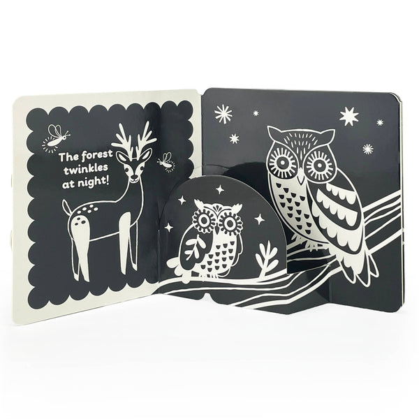 Children's book with black and white illustrations of a deer and an owl on a night sky background.