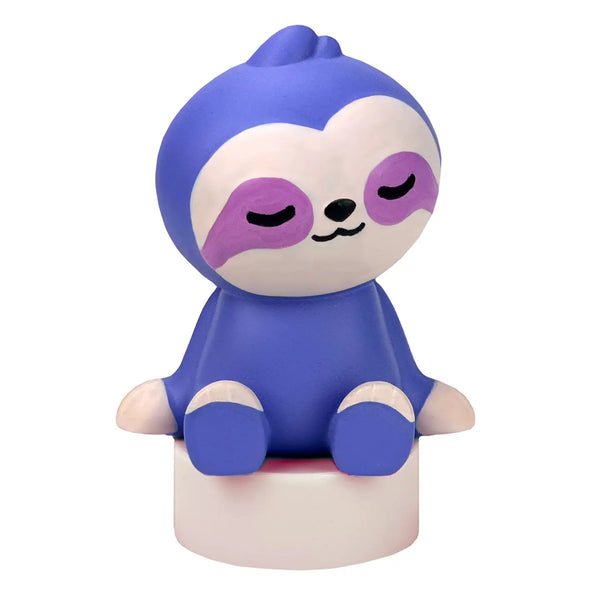 Purple sloth figurine with closed eyes on a white background