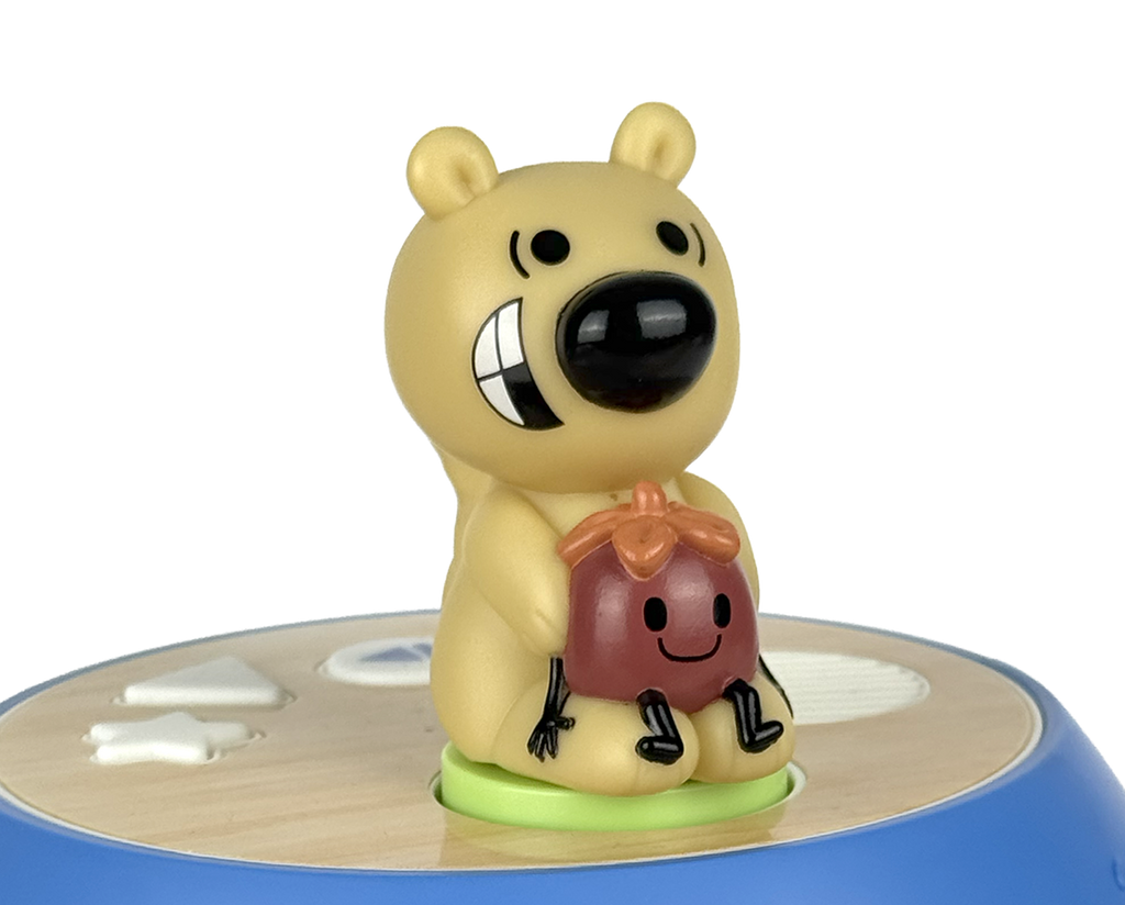 Toy figure of a bear holding a potted plant on a white background