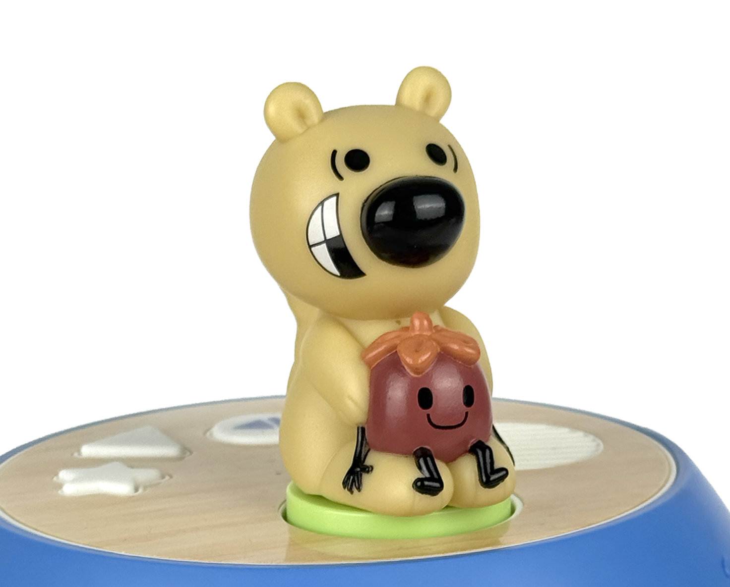 Toy figure of a bear holding a potted plant on a white background
