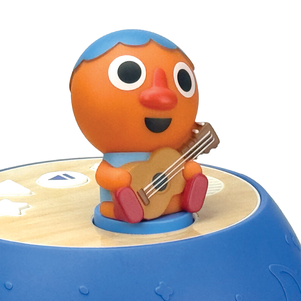 Toy figure of a character with an orange face and blue hair playing a guitar on a blue and beige base.