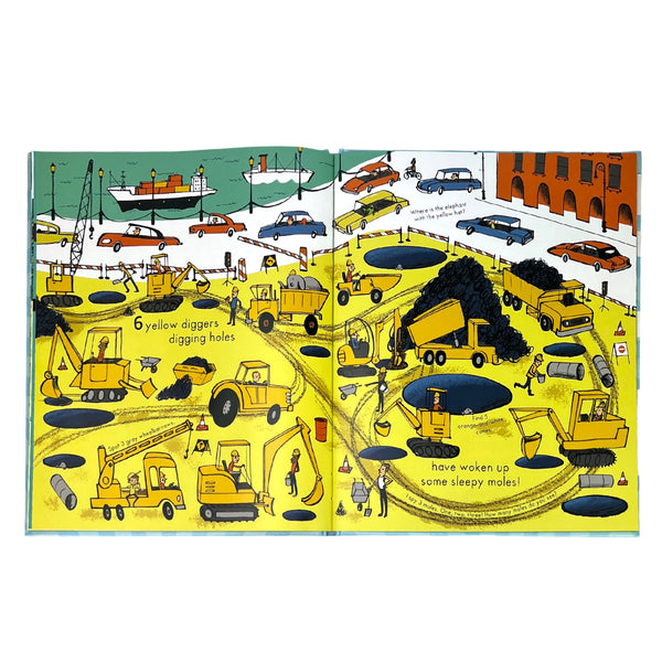 Illustrated book page with construction vehicles and workers on a city street.