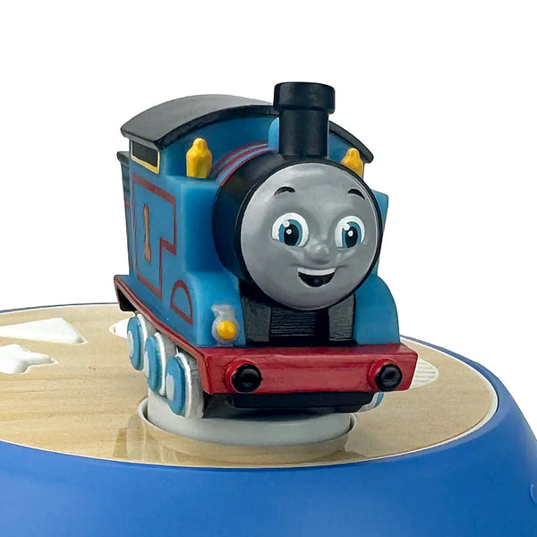 Toy train engine with a smiling face on a white background