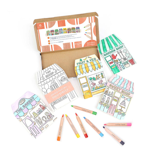 Coloring book set with illustrations of shops and colored pencils on a white background