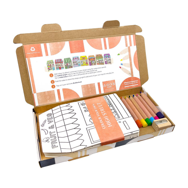Coloring book set with colored pencils and a cardboard cover on a white background