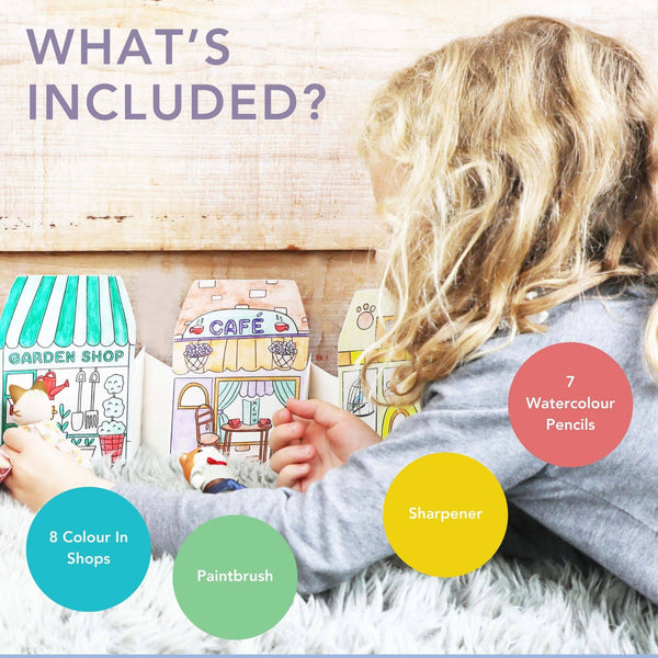 Child playing with toy shops and stationery items on a wooden floor.