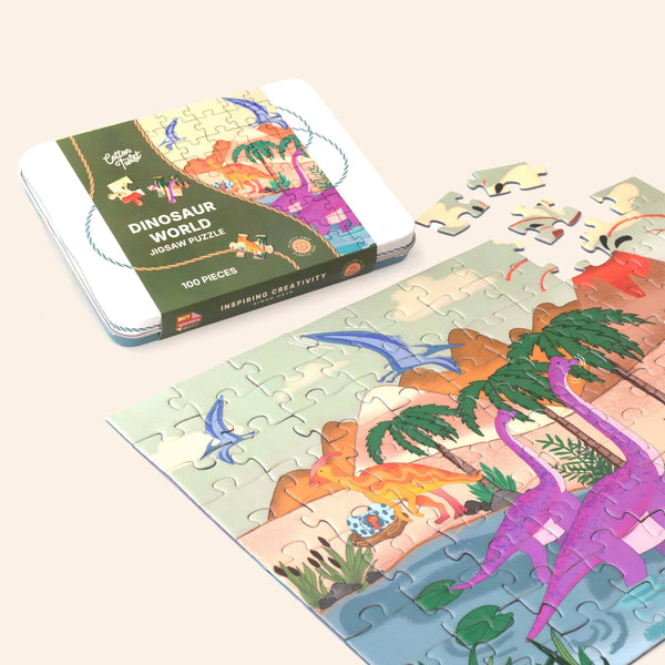 Dinosaur-themed jigsaw puzzle with completed pieces and packaging on a light background