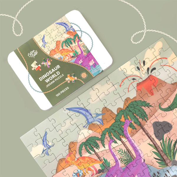 Dinosaur-themed jigsaw puzzle with packaging on a light green background