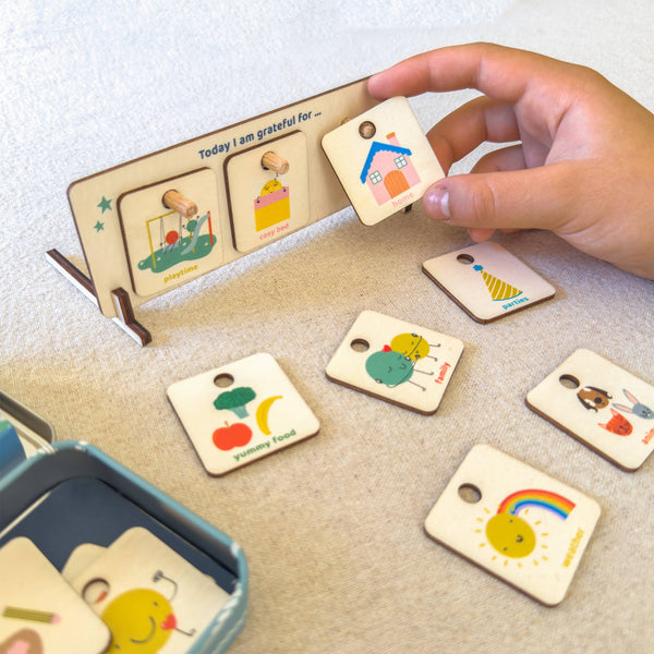 Hand interacting with a set of colorful wooden cards on a light surface