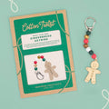 Gingerbread keyring craft kit with packaging on a light green background