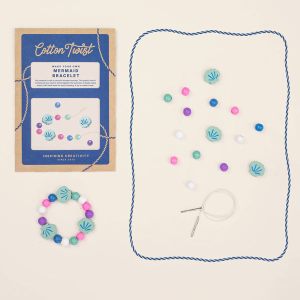 Mermaid bracelet kit with packaging and materials on a beige background