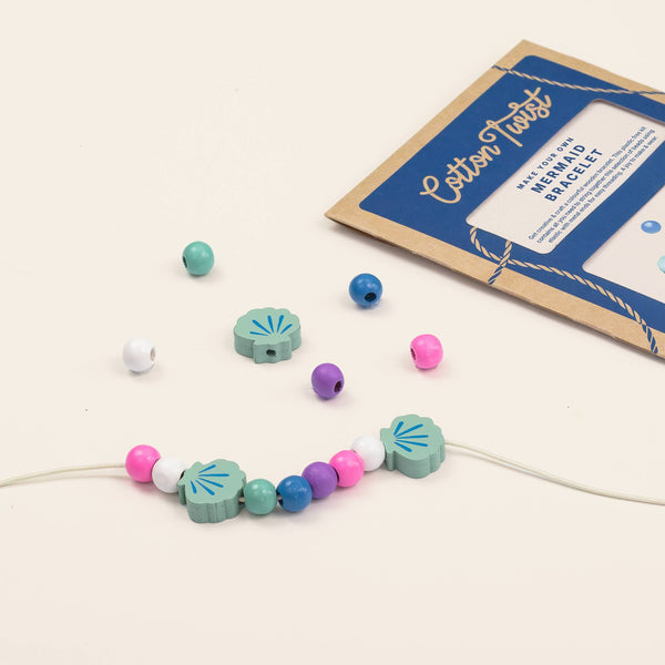 Colorful beaded bracelet with a cardboard packaging on a light background