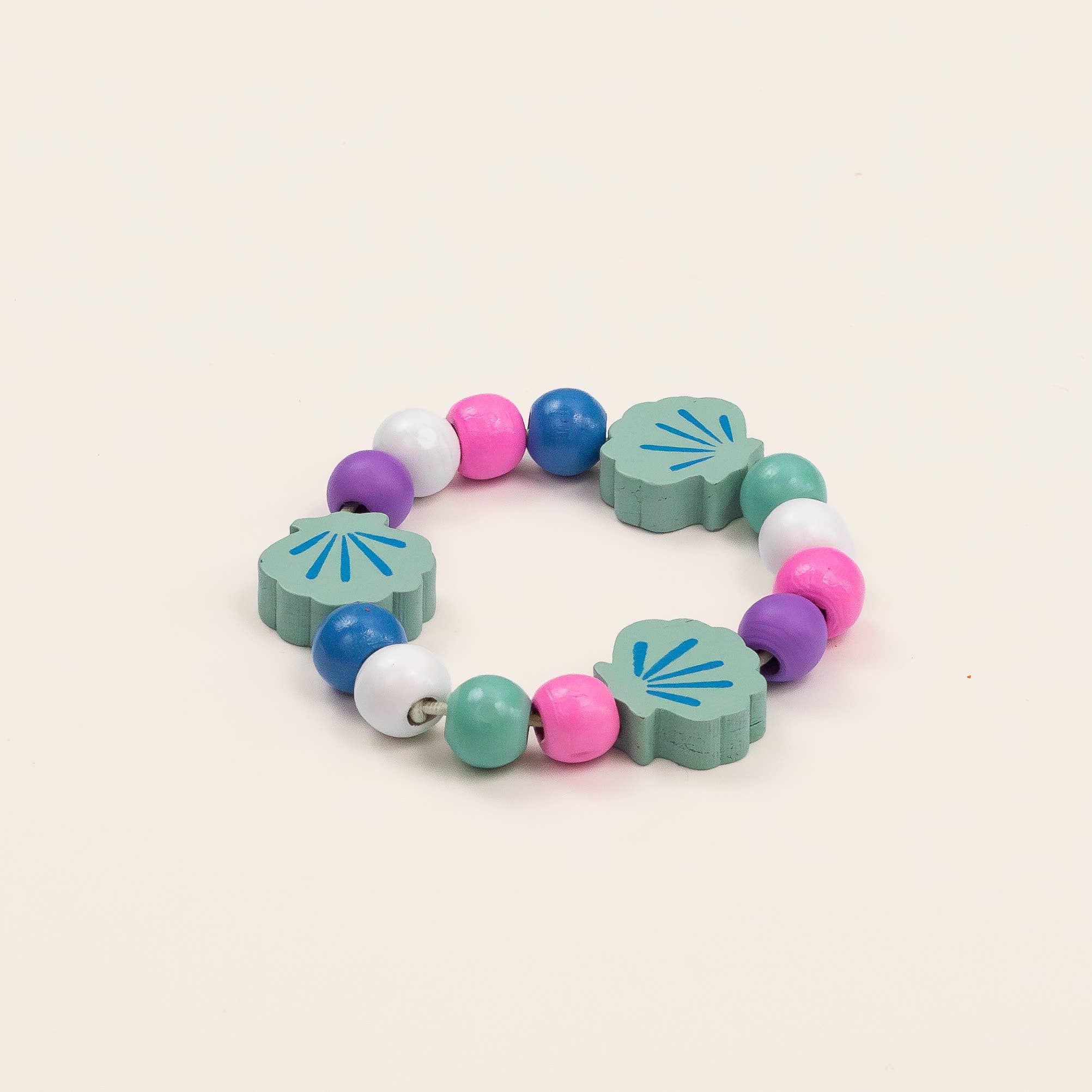 Colorful children's bracelet with floral-shaped beads on a beige background