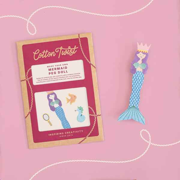 Mermaid peg doll with packaging on a pink background