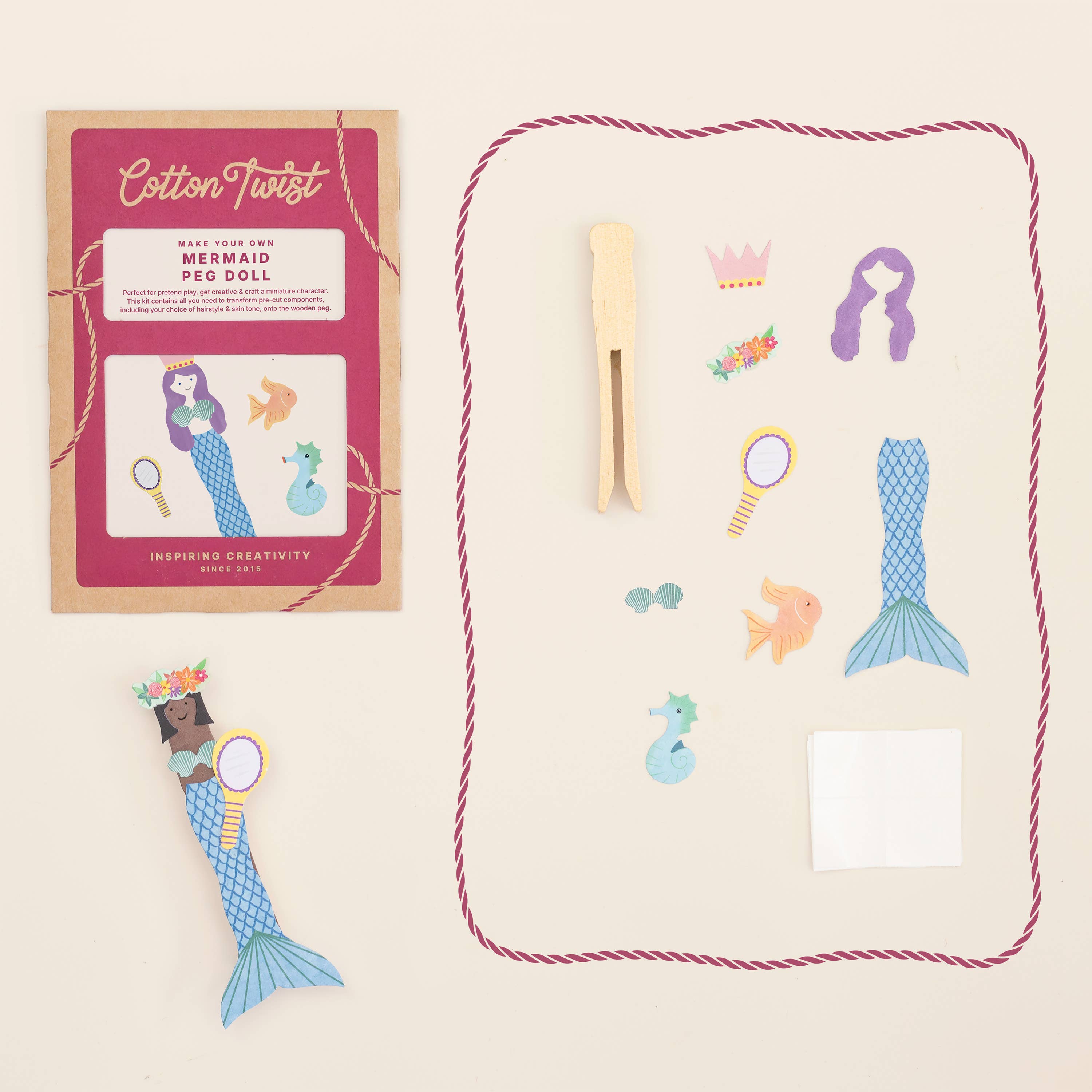 Mermaid peg dolls set with packaging and pegs on a beige background