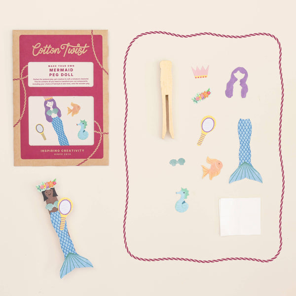 Mermaid peg dolls set with packaging and pegs on a beige background