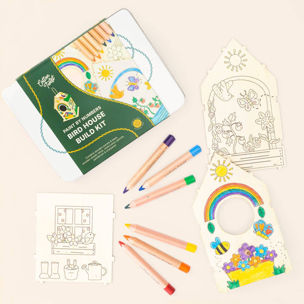 Bird house build kit with coloring pages and markers on a beige background