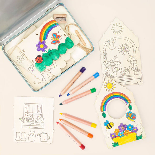 Coloring kit with coloring book, markers, and stencils on a light background