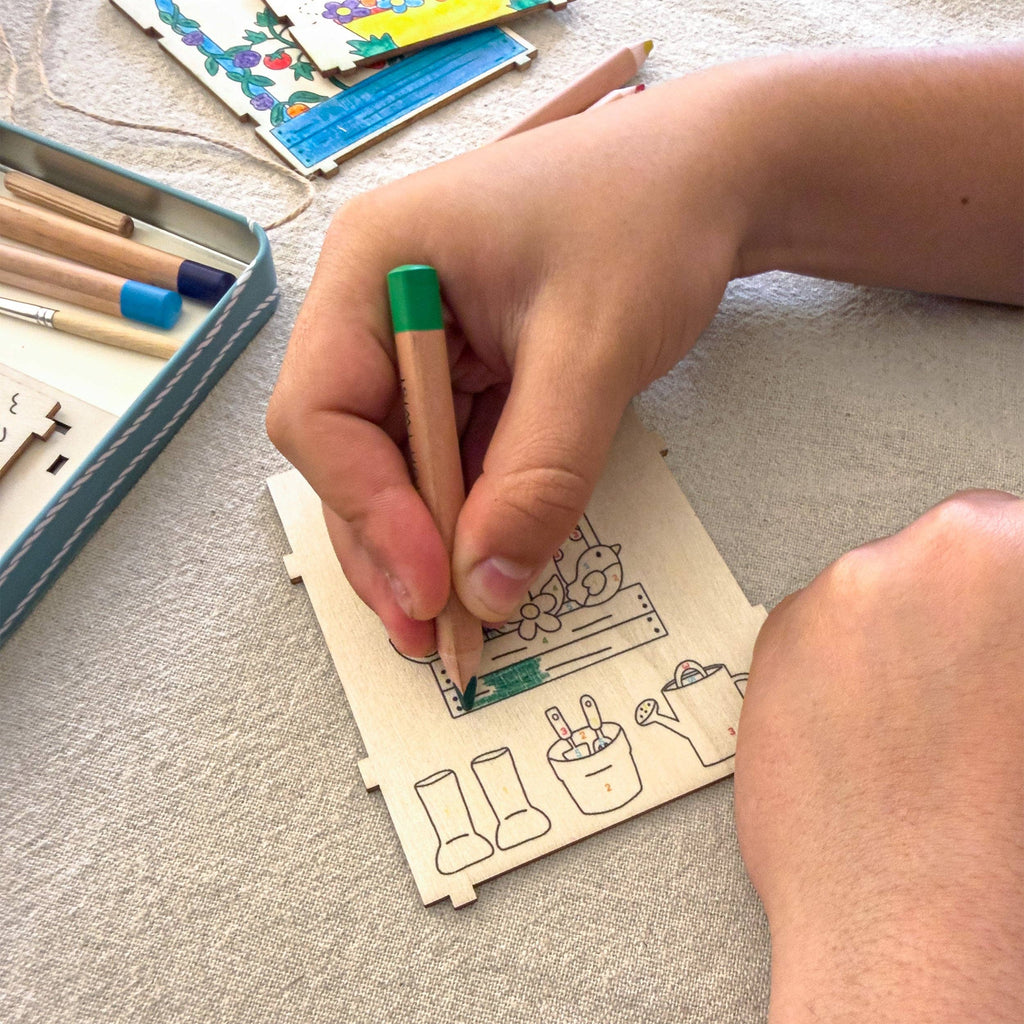 Person coloring a picture with a pencil on a textured surface