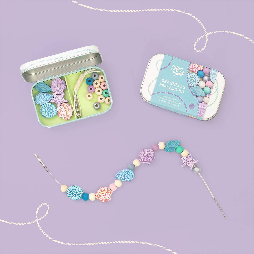 Seashell bracelet kit with open tin and completed bracelet on a purple background