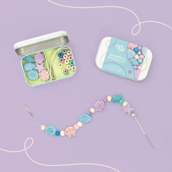 Seashell bracelet kit with open tin and completed bracelet on a purple background