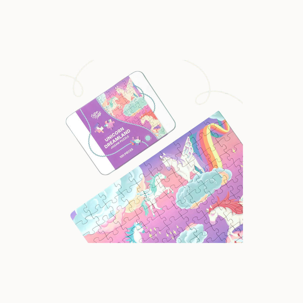 A colorful jigsaw puzzle featuring whimsical unicorn illustrations in pastel shades of purple, pink, blue, and yellow, shown both assembled and partially disassembled on a plain light background.