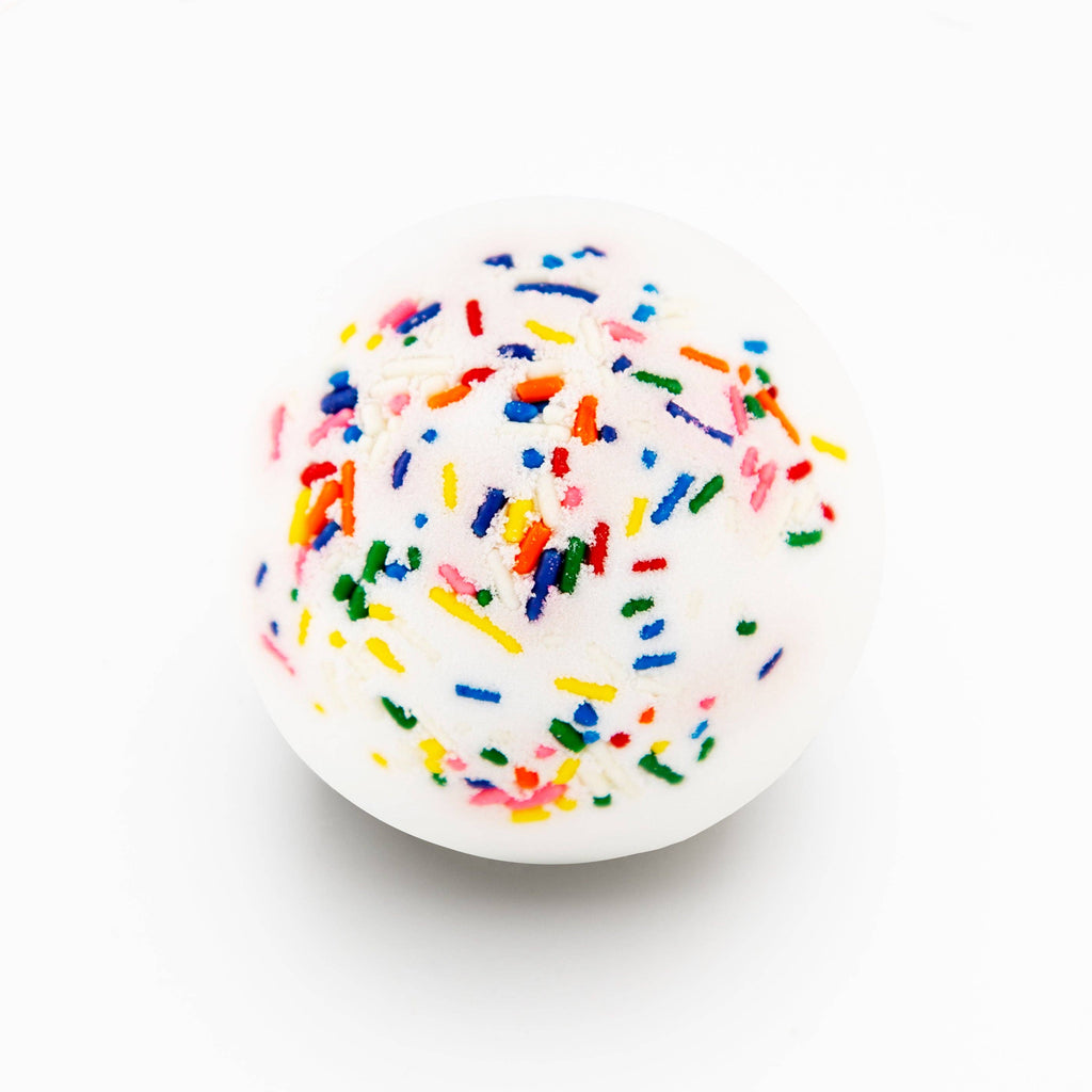 White spherical object with colorful sprinkles on a white background