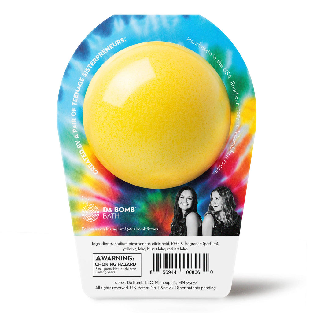 Yellow bath bomb in a colorful packaging with branding and product details.