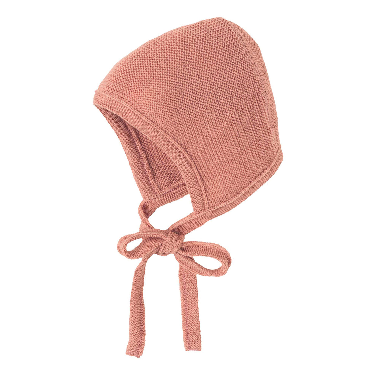 Knitted baby bonnet in pink on a white background