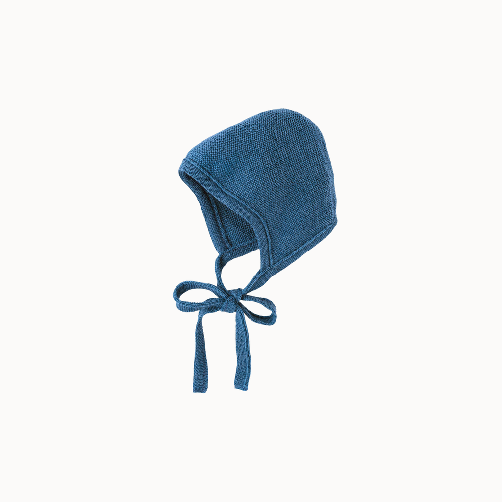 Blue knitted baby bonnet on white background