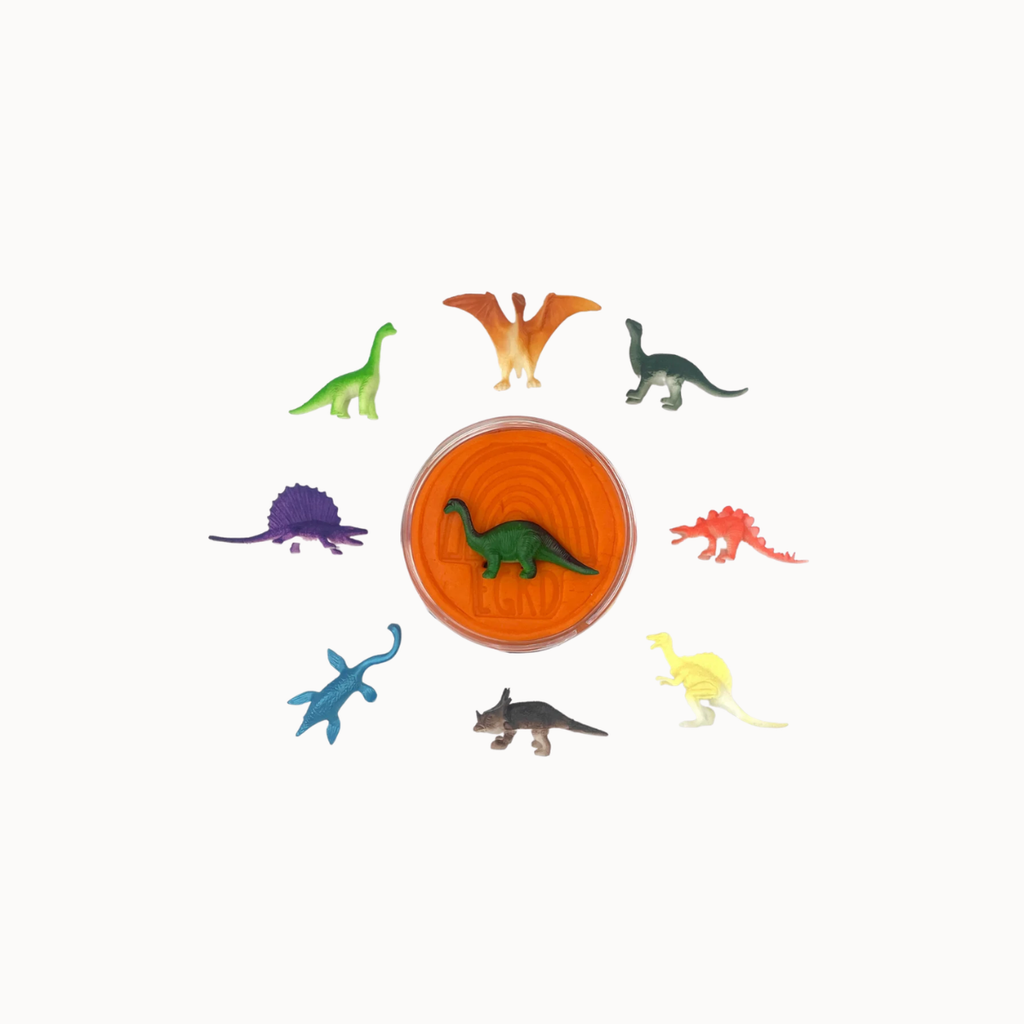A set of colorful plastic dinosaur toy figures arranged in a circle around a central round orange container on a plain white background.