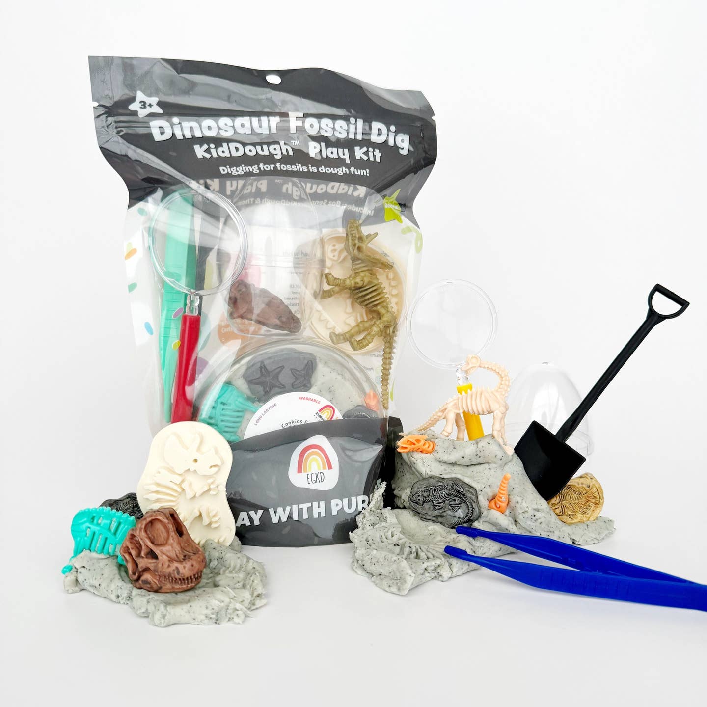 Dinosaur Fossil Dig KidDough Play Kit with tools on a white background
