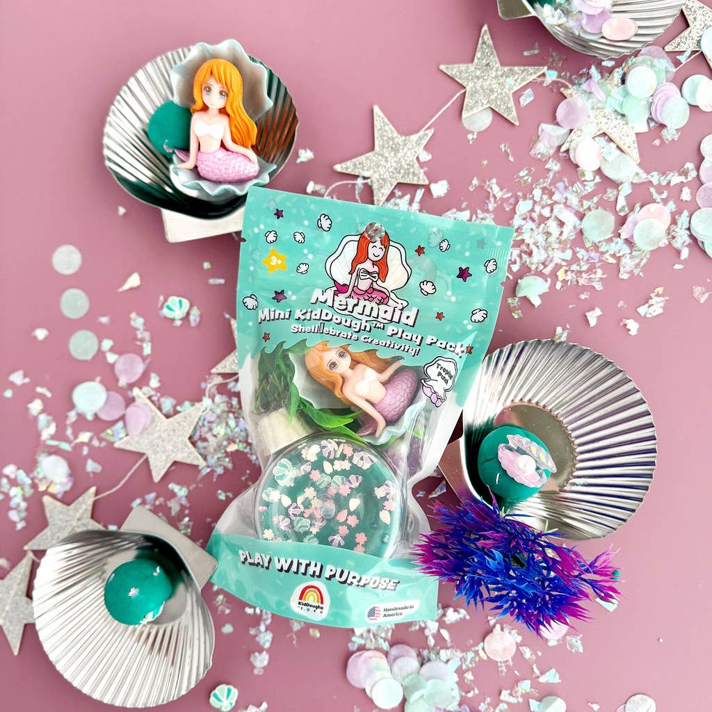 Mermaid-themed play dough set with packaging on a pink background
