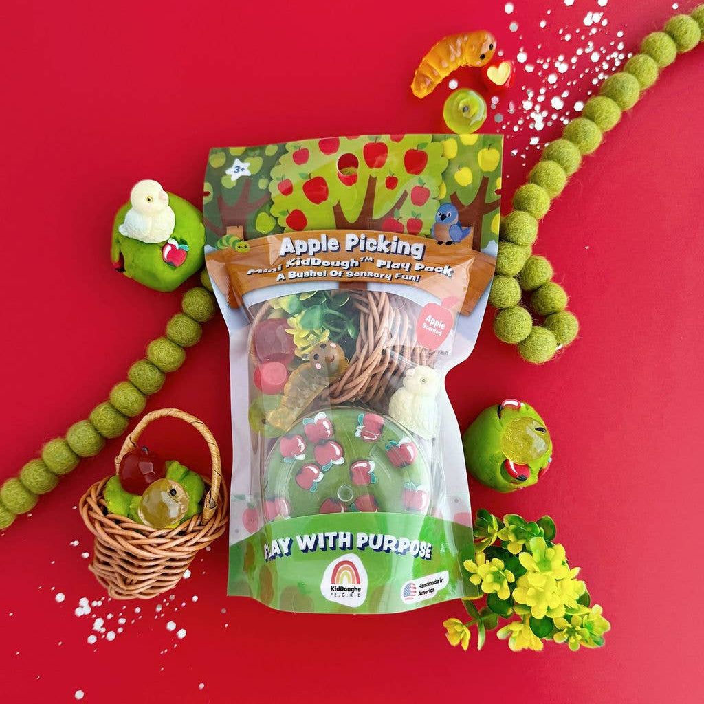 Play dough package with green play dough, tools, and accessories on a red background