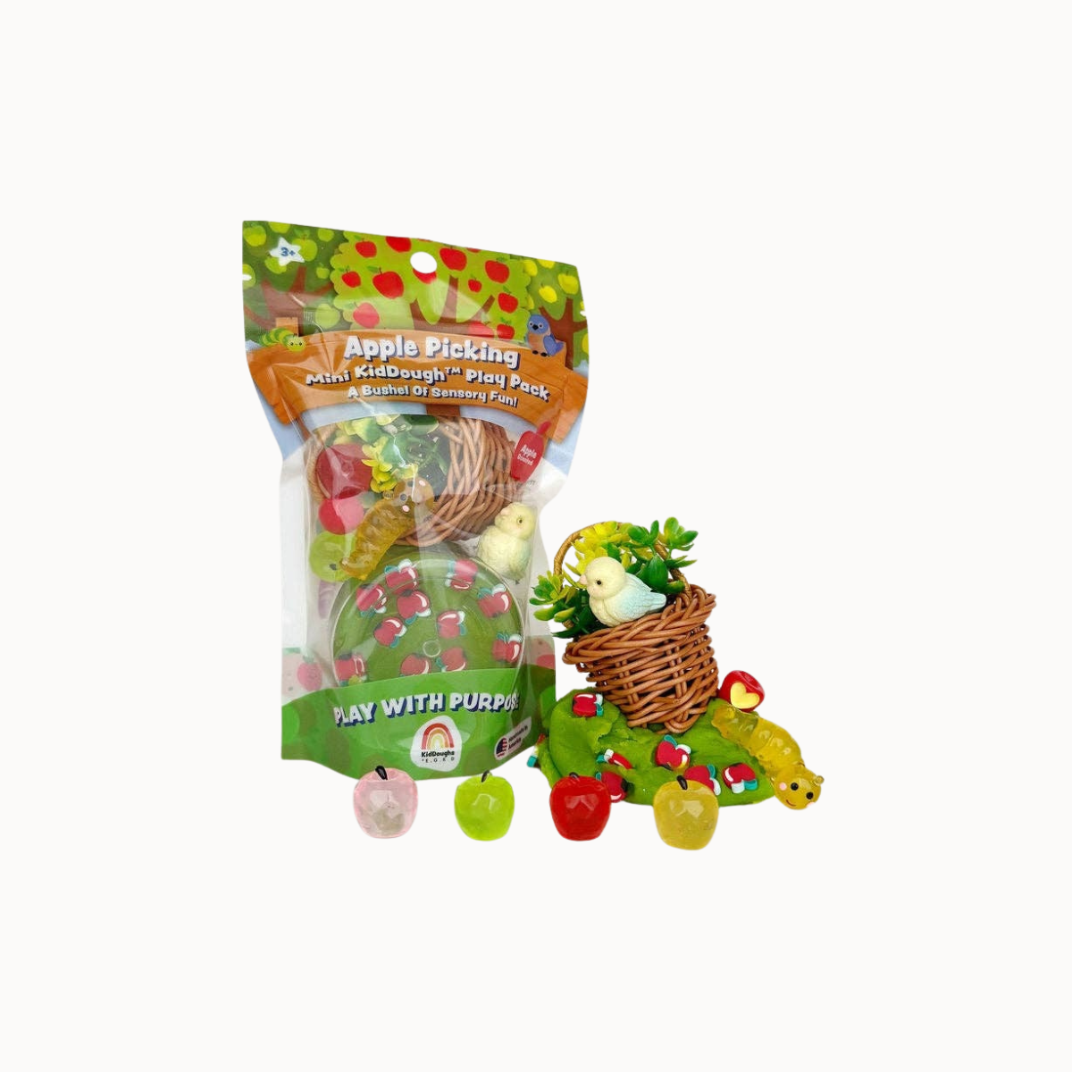 An Easter-themed 'Apple Picking' mini egg hunt play set, featuring a clear plastic bag with green and orange graphics, accompanied by several small plastic eggs, baskets, and apples on a plain white background.
