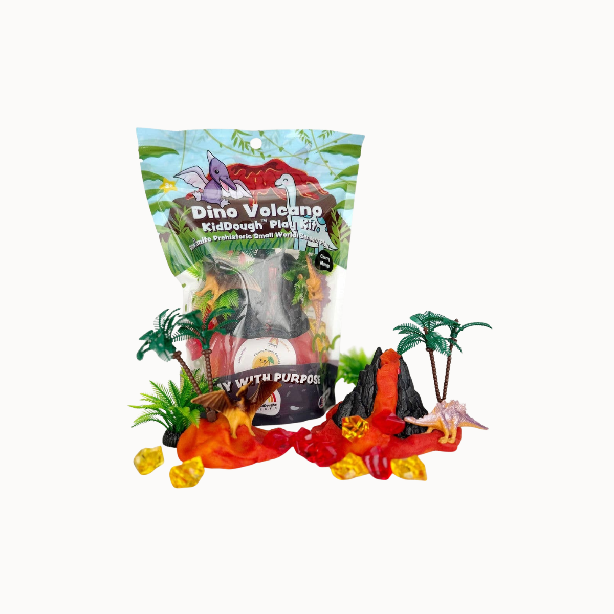 A bag of Dino Volcano KidDeough Pie Pits toy set displayed on a clean white background, surrounded by its included volcano, lava, rocks, and small dino figures.