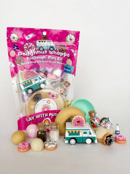 Doughnut-themed play kit with packaging, toys, and accessories on a white background