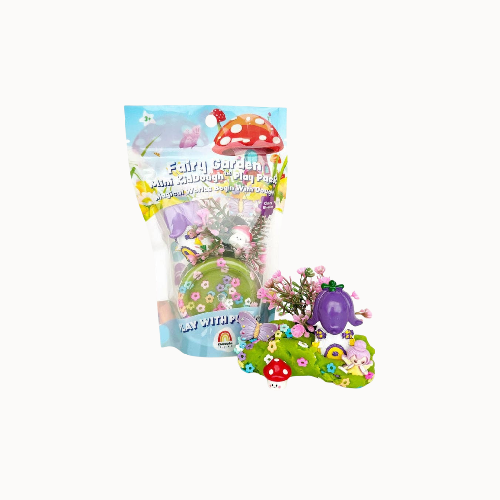 A packaged craft kit labeled 'Easter Fairy Garden mini Art & Craft Pack' with a clear bag showing colorful fairy garden pieces inside, plus a small assembled example of the craft set placed in front on a white background.