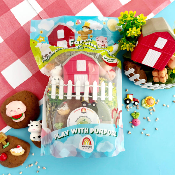 Farm-themed toy set with packaging on a checkered tablecloth