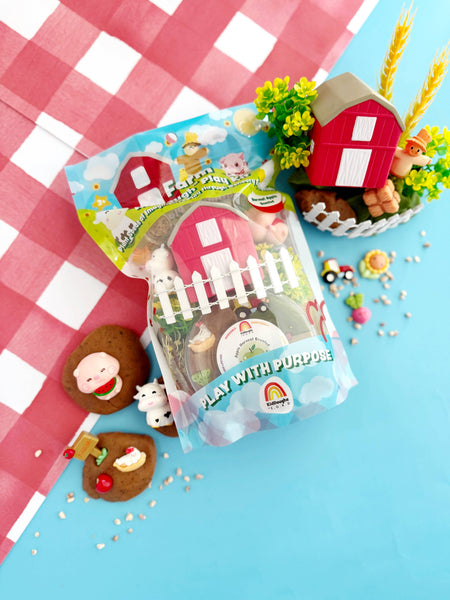 Playset packaging with farm-themed toys on a checkered tablecloth