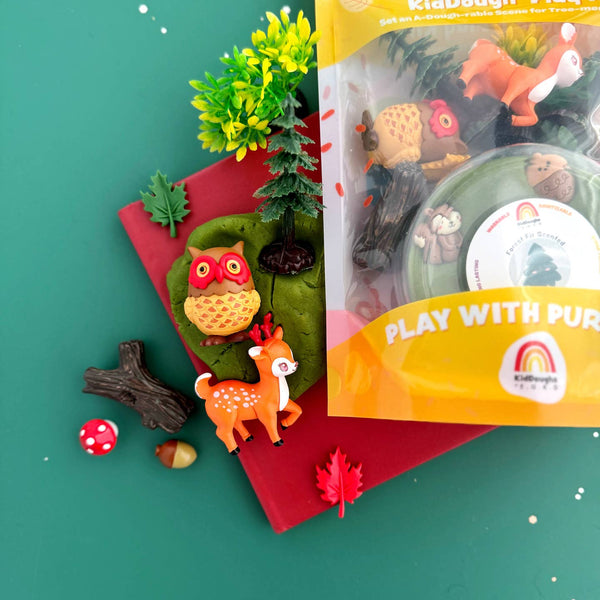 Playset with animals and nature elements on a green background, featuring 'KidBougie' packaging.