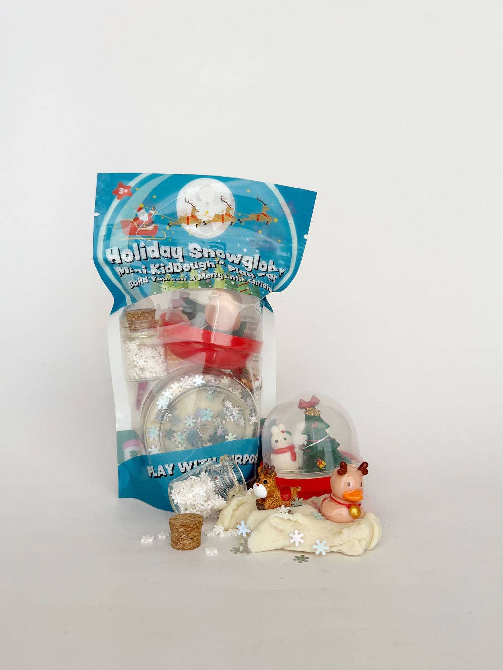 Holiday snowglobe set with packaging on a white background