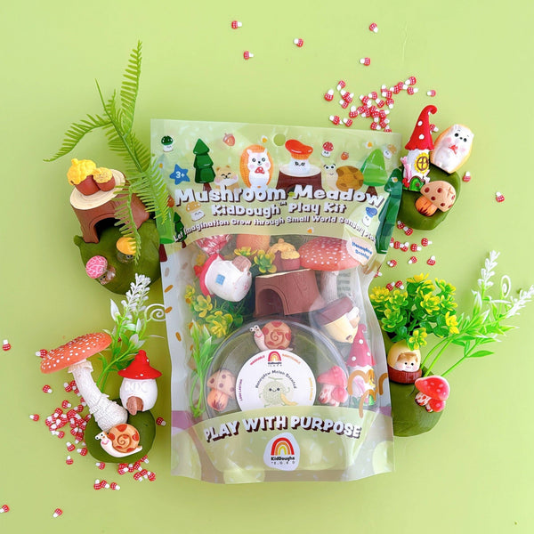 Mushroom Meadow play kit packaging on a green background with small garden accessories.