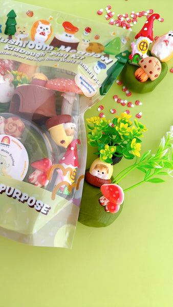 Fimo clay figures with packaging on a green surface